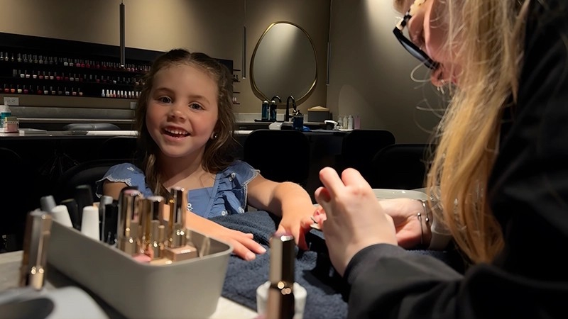 Girl receiving manicure service
